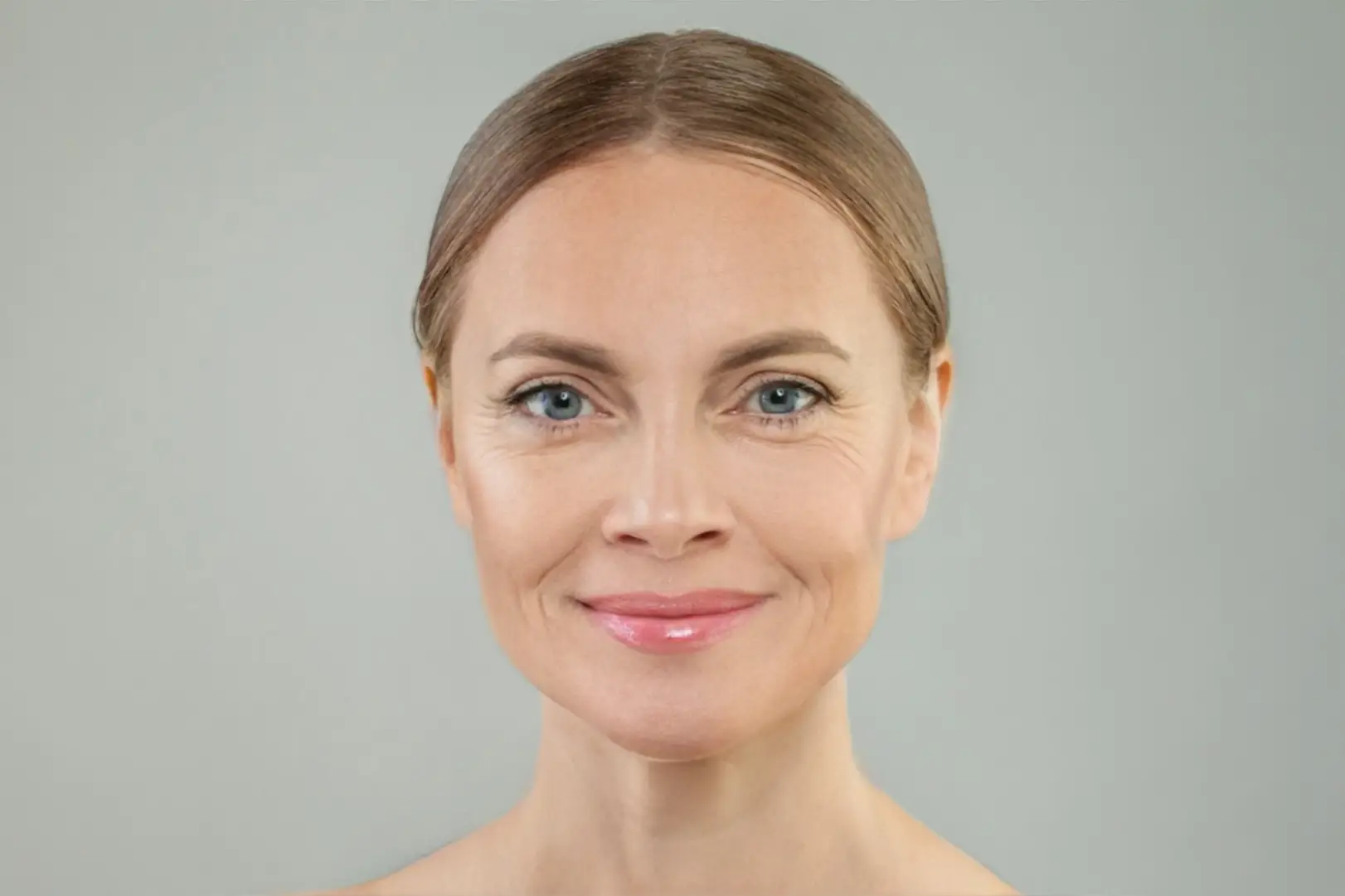Front-facing portrait of a mature woman with visible facial lines around her eyes and mouth.